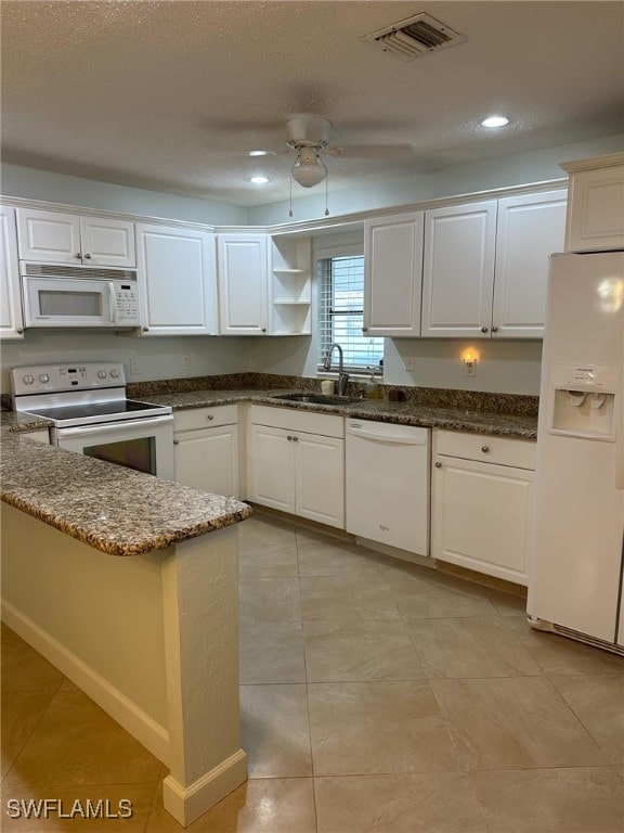 kitchen with white appliances, sink, white cabinetry, and ceiling fan