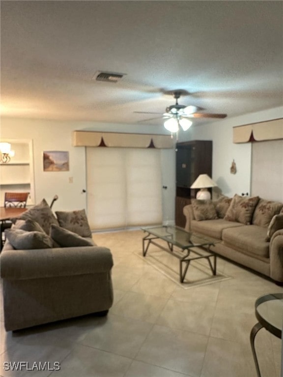 living room featuring ceiling fan with notable chandelier