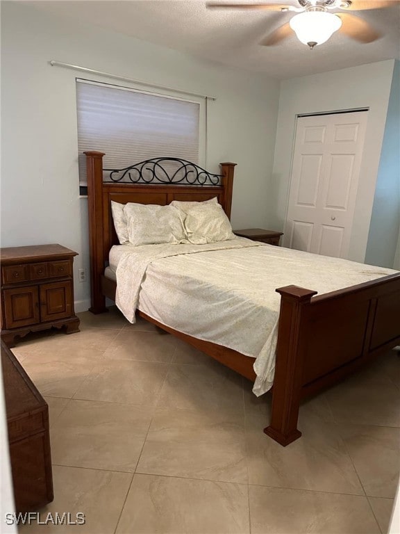 tiled bedroom featuring a closet and ceiling fan