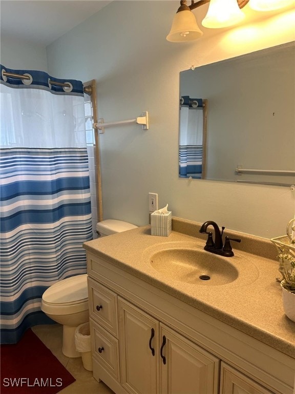 bathroom featuring curtained shower, tile patterned flooring, toilet, and vanity