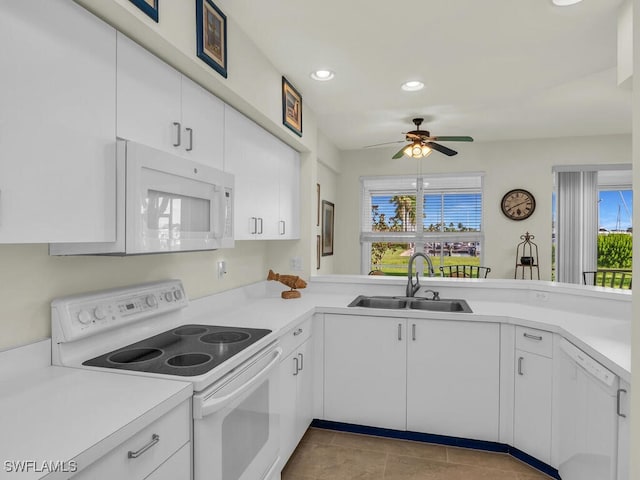 kitchen with a wealth of natural light, ceiling fan, sink, and white appliances