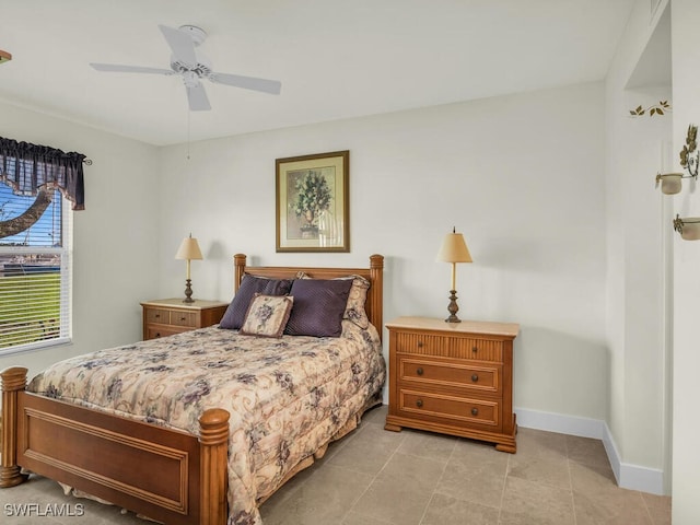 bedroom with ceiling fan and light tile patterned floors