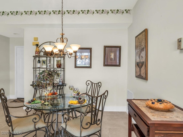 tiled dining space featuring a notable chandelier