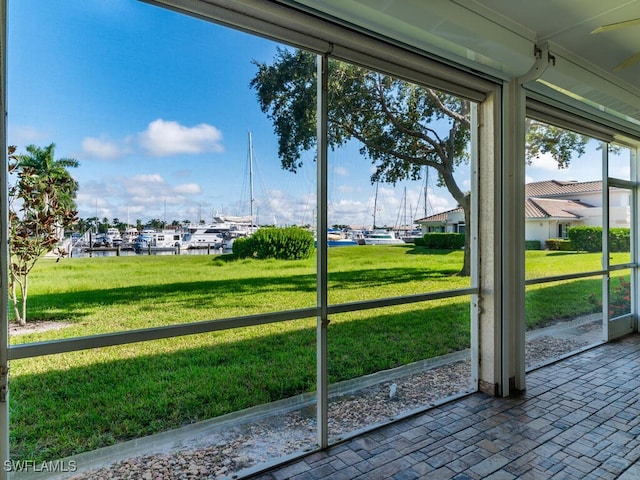 unfurnished sunroom featuring a water view