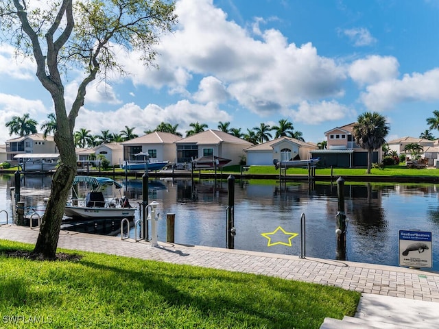 view of dock featuring a water view and a yard