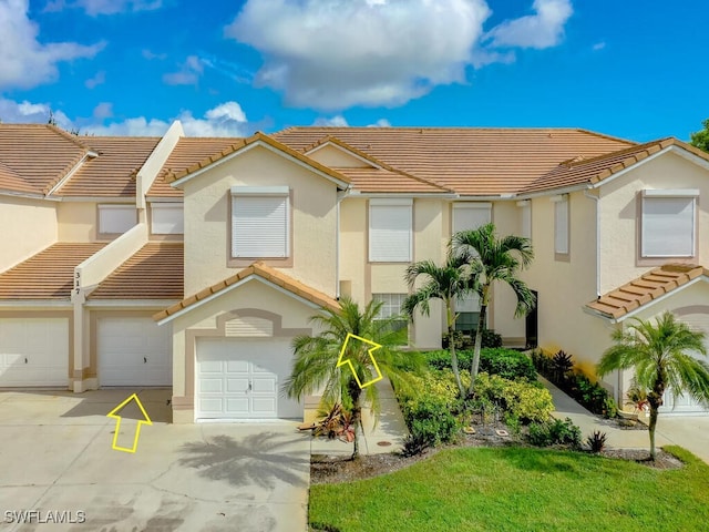 view of front of property with a garage and a front lawn