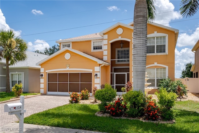 view of front of home featuring a garage and a front lawn