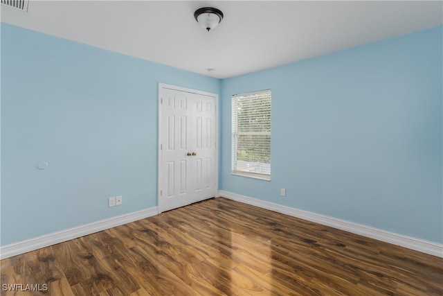 unfurnished room featuring dark hardwood / wood-style floors