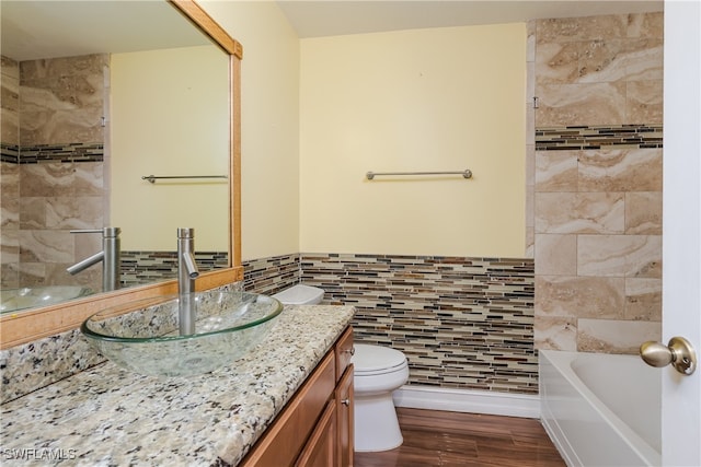 full bathroom featuring separate shower and tub, toilet, tile walls, wood-type flooring, and vanity