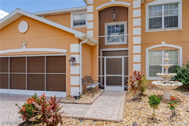 doorway to property with a garage