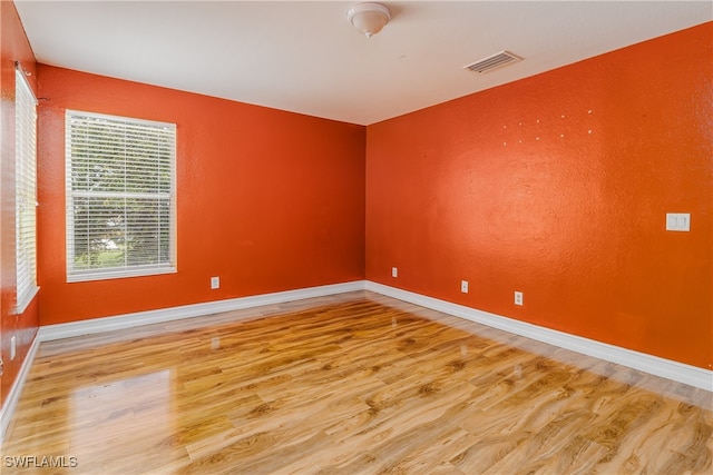 spare room with wood-type flooring