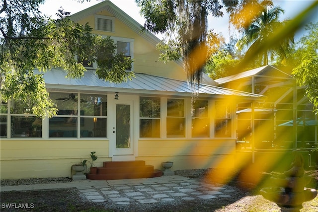 view of exterior entry with a standing seam roof and metal roof