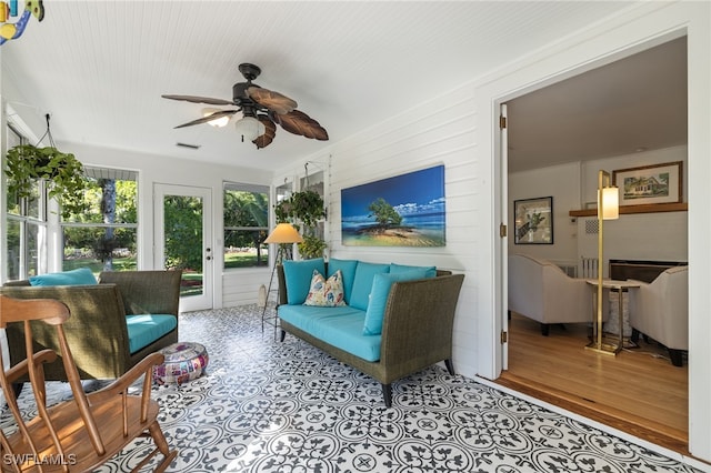 sunroom featuring ceiling fan