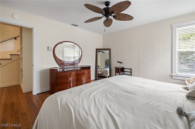 bedroom with ceiling fan and dark hardwood / wood-style floors