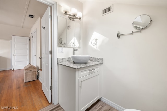 bathroom with vanity and hardwood / wood-style flooring