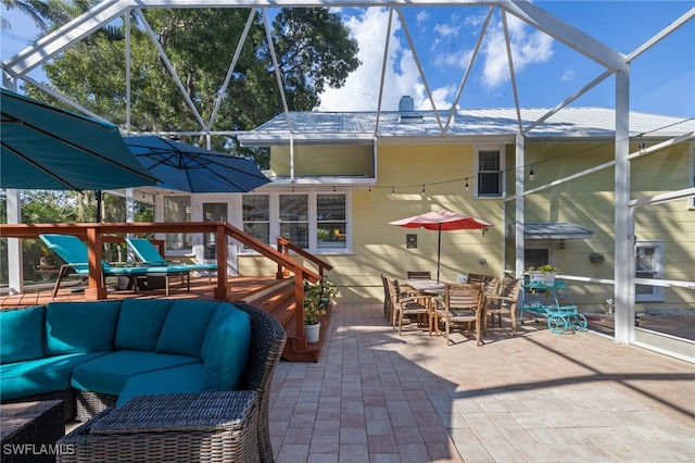 view of patio featuring an outdoor hangout area, a wooden deck, and glass enclosure