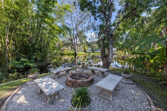 view of patio / terrace with an outdoor fire pit and a water view