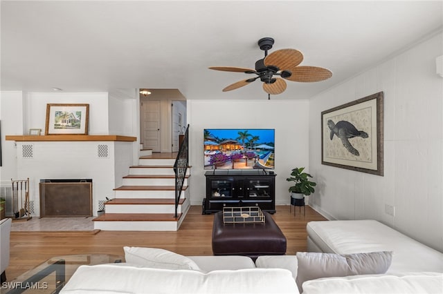 living room featuring hardwood / wood-style flooring and ceiling fan