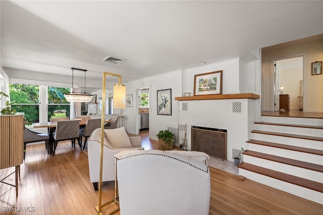 living room featuring light wood-type flooring and plenty of natural light