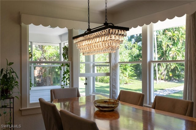 dining room with a notable chandelier and wood-type flooring