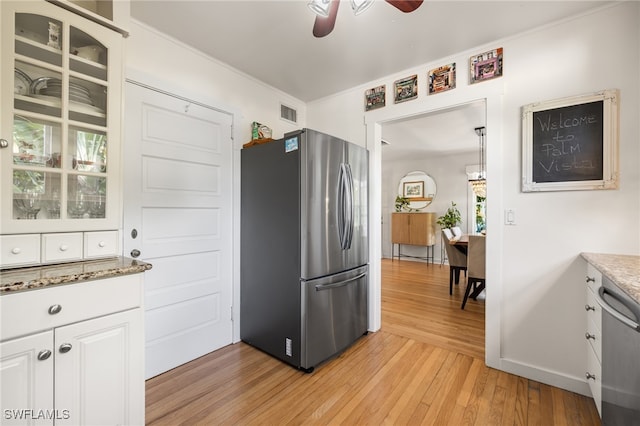 kitchen featuring white cabinetry, ceiling fan, appliances with stainless steel finishes, and light wood-type flooring