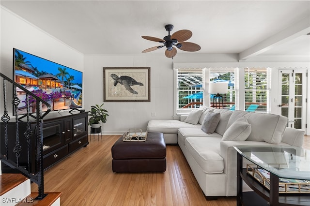 living room with beam ceiling, hardwood / wood-style flooring, plenty of natural light, and ceiling fan