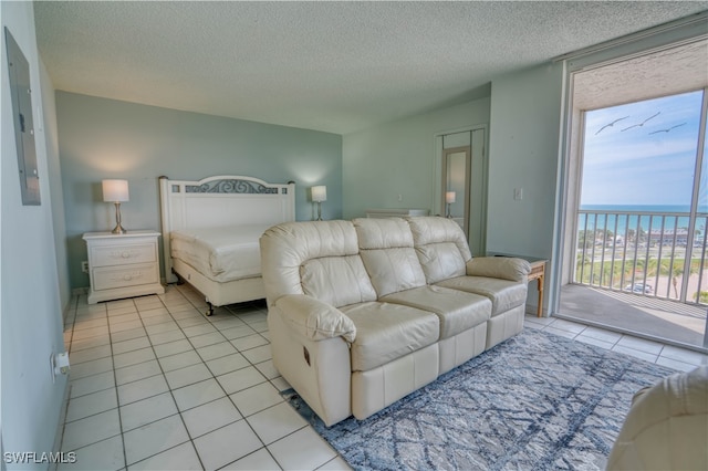 tiled bedroom featuring access to exterior and a textured ceiling