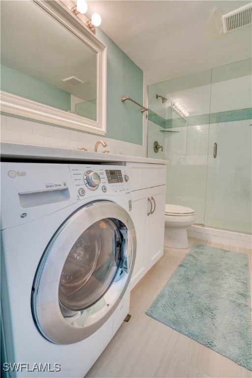 interior space featuring washer / clothes dryer, tile walls, toilet, and walk in shower