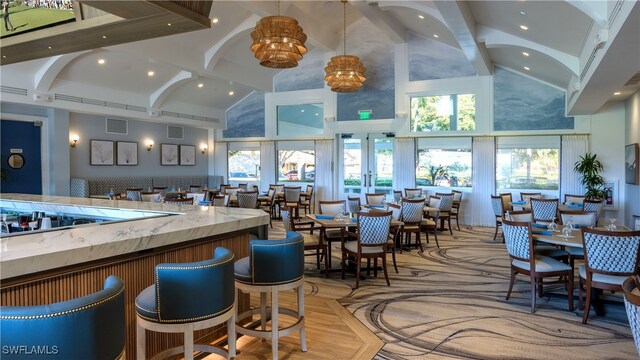 11745 Quail Village Way, Naples, FL 34119 - bar with high vaulted ceiling, beam ceiling, recessed lighting, french doors, and decorative light fixtures