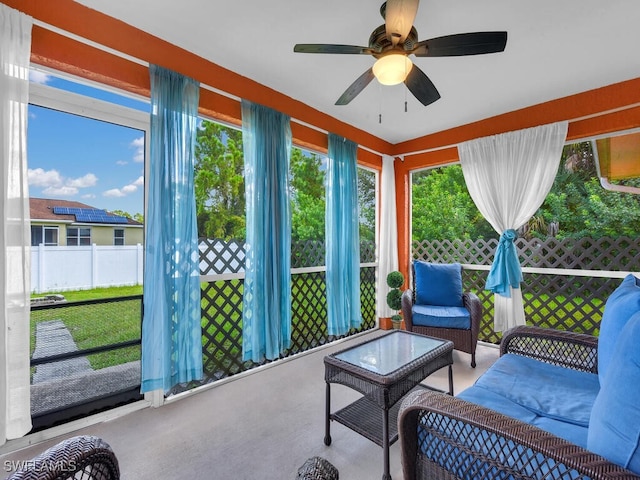 sunroom / solarium featuring ceiling fan