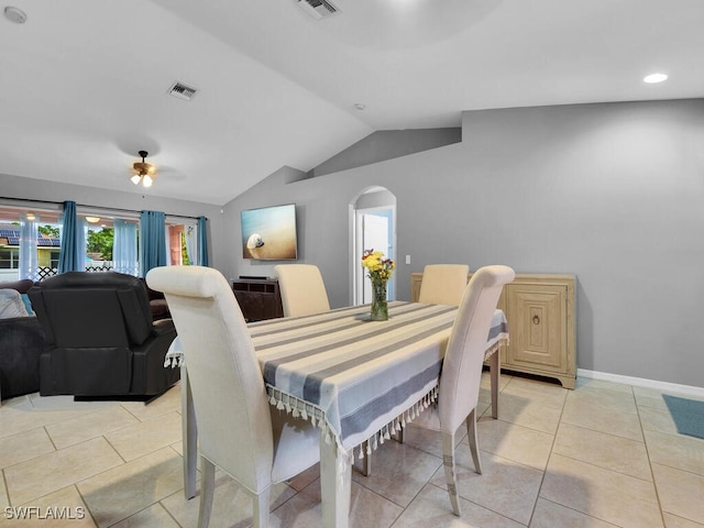 tiled dining area featuring lofted ceiling and ceiling fan