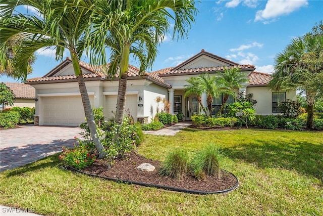 mediterranean / spanish house with a front lawn and a garage