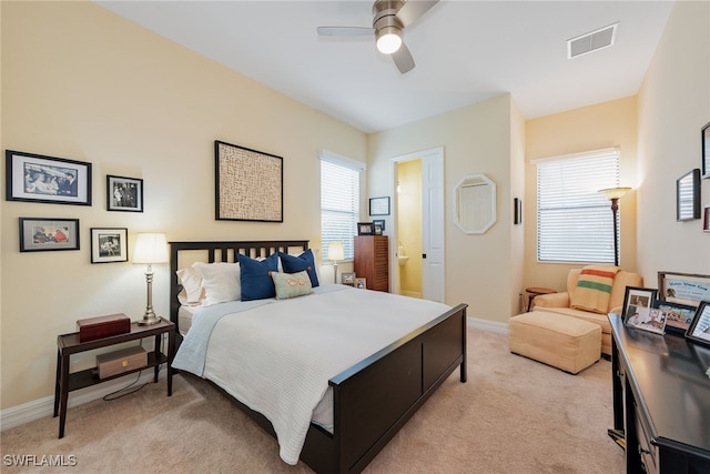 bedroom with light carpet and ceiling fan