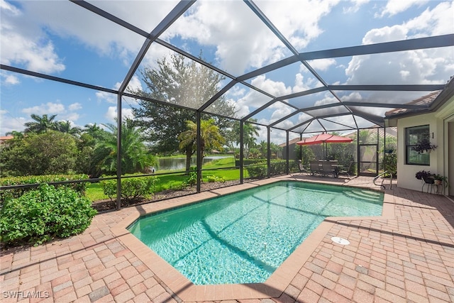 view of swimming pool with a water view, a patio area, and a lanai