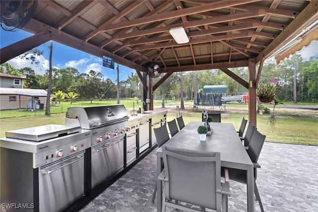 view of patio / terrace with area for grilling, sink, and a gazebo