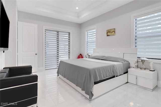 bedroom featuring a tray ceiling and light tile patterned flooring