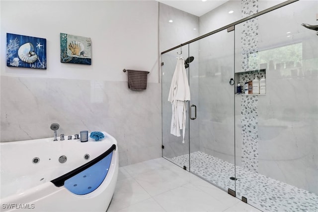 bathroom featuring tile walls and plus walk in shower