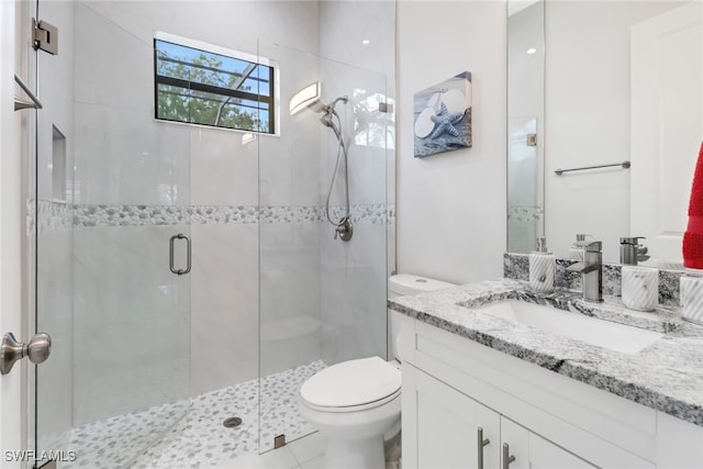 bathroom featuring vanity, toilet, walk in shower, and tile patterned flooring