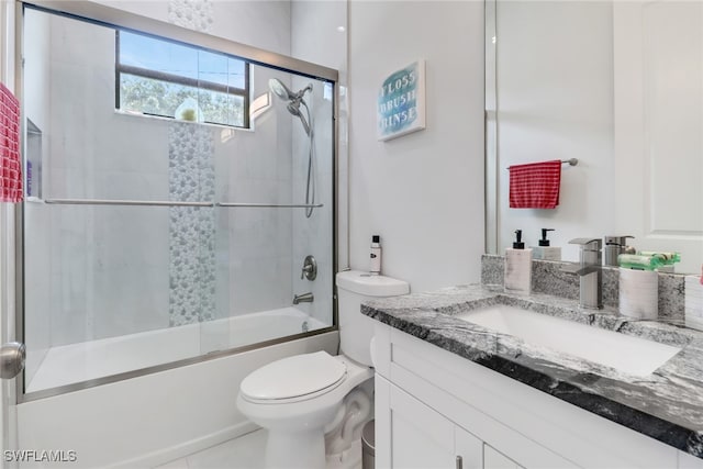 full bathroom with vanity, toilet, tile patterned floors, and bath / shower combo with glass door