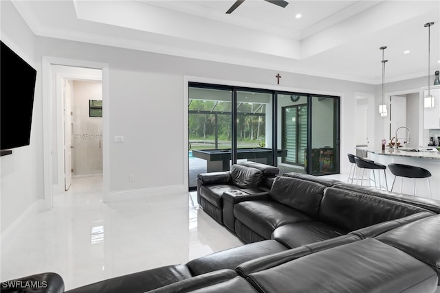 living room featuring crown molding and ceiling fan