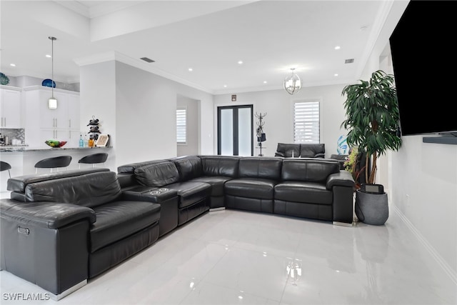 living room featuring crown molding, plenty of natural light, and a chandelier