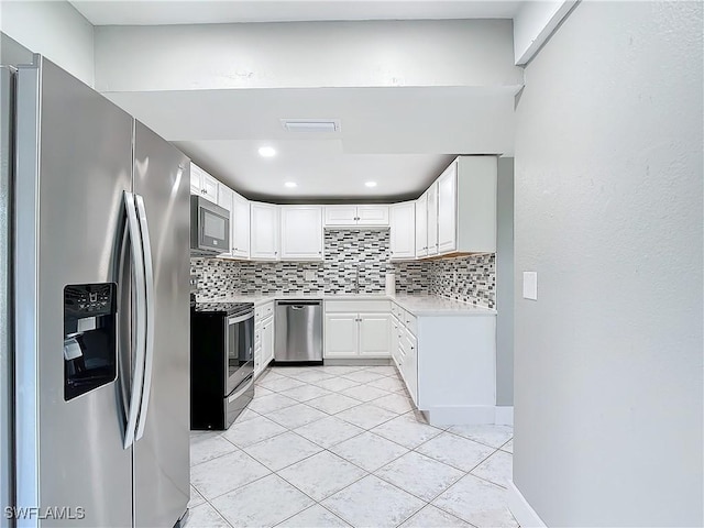 kitchen featuring tasteful backsplash, stainless steel appliances, and white cabinets