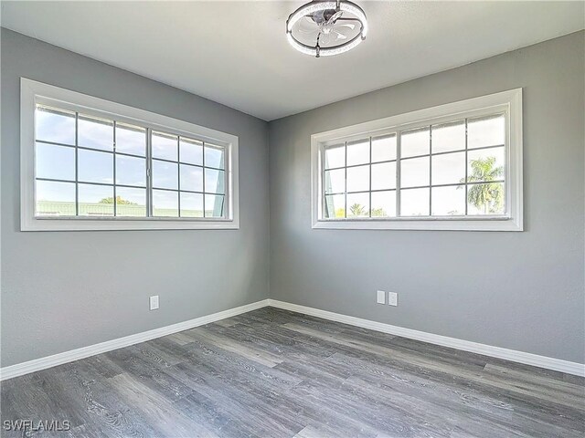 unfurnished room featuring dark hardwood / wood-style flooring