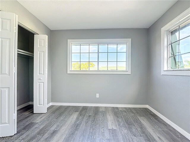 unfurnished bedroom with wood-type flooring