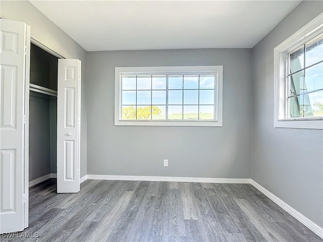 4802 Albacore Ln, Fort Myers, FL 33919 - unfurnished bedroom with a closet, baseboards, and wood finished floors