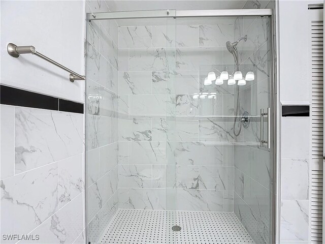 bathroom featuring a shower with door