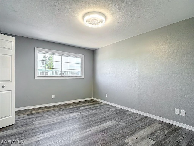 4802 Albacore Ln, Fort Myers, FL 33919 - unfurnished room featuring dark wood-style floors, baseboards, and a textured ceiling