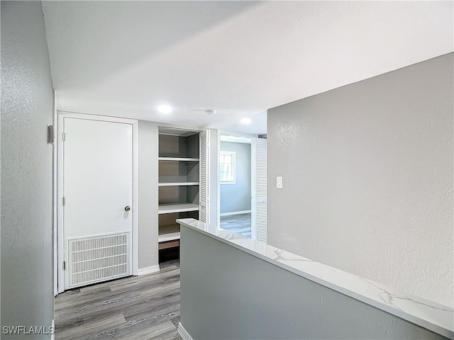 4802 Albacore Ln, Fort Myers, FL 33919 - hallway featuring wood finished floors, visible vents, and a textured wall