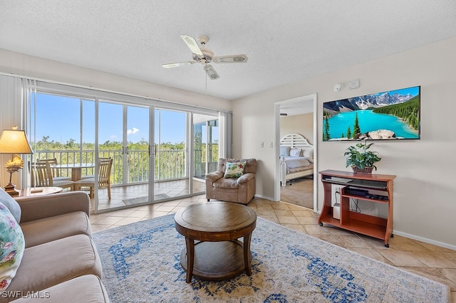 tiled living room with a textured ceiling and ceiling fan