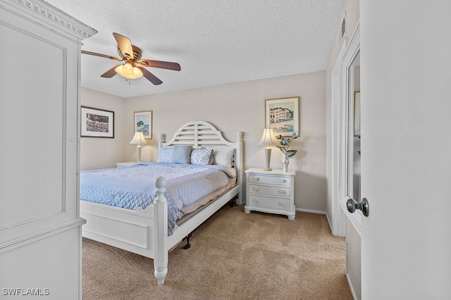 carpeted bedroom with ceiling fan and a textured ceiling